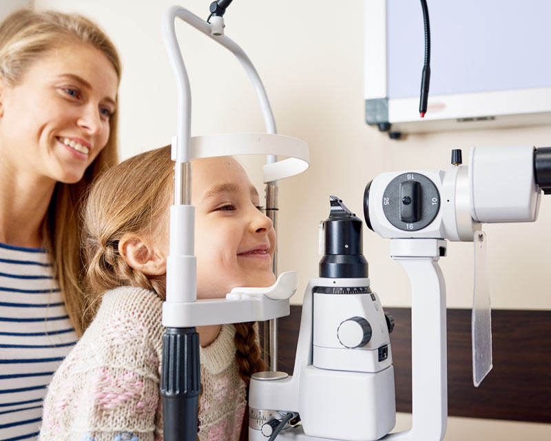 a little girl getting an eye exam